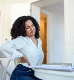 Woman suffering from lower back pain in Cincinnati.
