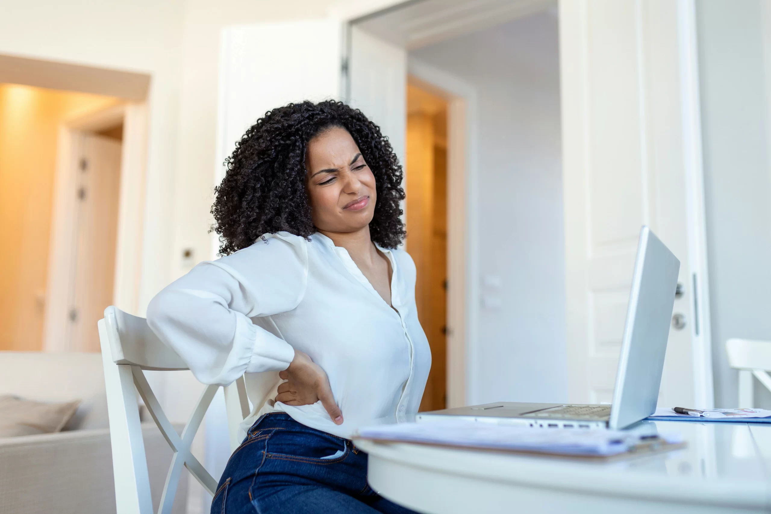 Woman suffering from lower back pain in Cincinnati.